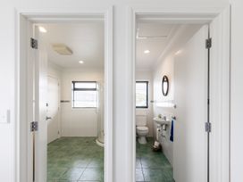 A bathroom featuring a shower, toilet, and sink at Manaia Magic - Tairua Holiday Home Tairua