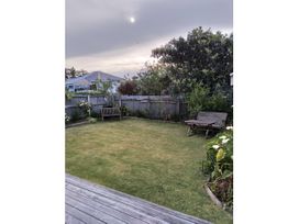 A garden with benches and a table at Le Solterre - Akaroa Holiday Home in Akaroa