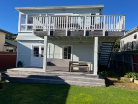 A house with a balcony and outdoor furniture at Le Solterre - Akaroa Holiday Home Akaroa