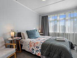 A bedroom with a bed and side table at Bliss on Barratt - Blenheim Holiday Home