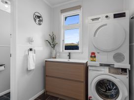 A laundry room with a washing machine and dryer at Bliss on Barratt - Blenheim Holiday Home
