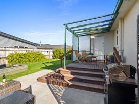 A deck with seating and a grill at Bliss on Barratt - Blenheim