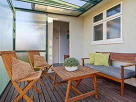 A sunroom with seating and a table at Bliss on Barratt - Blenheim