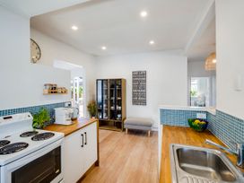 A kitchen with a stove and sink at Bird and Fish - Napier Holiday Home, Napier