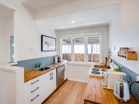A kitchen with a sink and window at Bird and Fish - Napier Holiday Home Napier