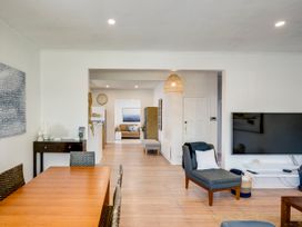 A living room with dining table and sofa at Bird and Fish - Napier Holiday Home, Napier