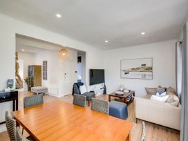 A dining room with a table and chairs at Bird and Fish - Napier Holiday Home