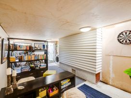 A room with a bookshelf and bicycles at Bird and Fish - Napier Holiday Home Napier