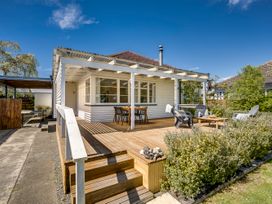 An outdoor area with a deck and seating at Bird and Fish - Napier Holiday Home, Napier