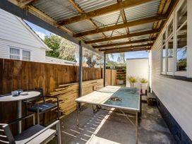 An outdoor area with a table and chairs at Bird and Fish - Napier Holiday Home, Napier