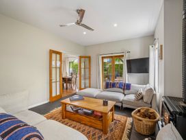 A living room with a sofa and coffee table at Kokomea House - Wanaka