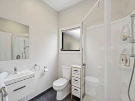 A bathroom with a sink, shower, and toilet at Kokomea House - Wanaka Holiday Home in Wanaka