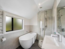 A bathroom with a bathtub and shower at Kokomea House - Wanaka