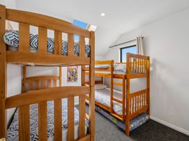 A bedroom with bunk beds and a window at Kokomea House - Wanaka