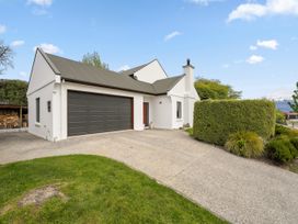 A house with a garage and driveway at Kokomea House - Wanaka Holiday Home Wanaka