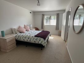 A bedroom with a bed and lamp at Views over Blenheim - Blenheim