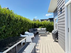 A patio with a sofa and table at Treasure on Tuscan - Martinborough Holiday Home Martinborough