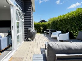 An outdoor area with furniture and barbecue grill at Treasure on Tuscan - Martinborough Holiday Home Martinborough