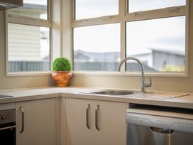 A kitchen with a sink and a potted plant at Fiordland Getaway - Te Anau Holiday Home, Fiordland