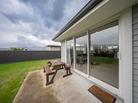 An outdoor area with a table and bench at Fiordland Getaway - Te Anau Holiday Home, Fiordland