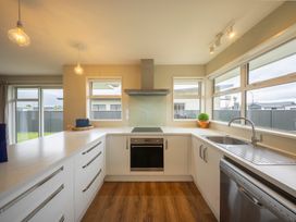 A kitchen with a sink and oven at Fiordland Getaway - Te Anau Holiday Home in Fiordland