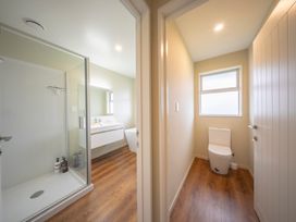 A bathroom with a shower and toilet at Fiordland Getaway - Te Anau Holiday Home in Fiordland