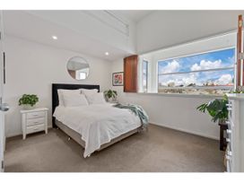 A bedroom with a bed and a window at Lakeview Luxury - Taupo Holiday Apartment in Taupo Central