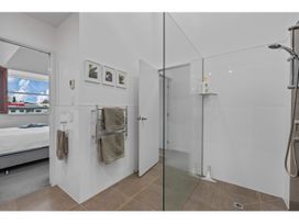 A bathroom with a shower and towel rack at Lakeview Luxury - Taupo Holiday Apartment in Taupo Central