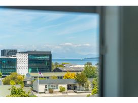 A view of buildings and water from a window at Lakeview Luxury - Taupo Holiday Apartment Taupo Central
