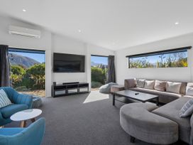 A living room with a sofa and television at Casa Central - Wanaka Holiday Home in Wanaka