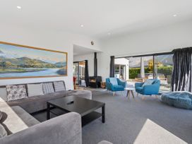 A living room with a sofa and armchairs at Casa Central - Wanaka Holiday Home Wanaka