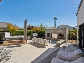 An outdoor area with a hot tub and seating at Casa Central - Wanaka Holiday Home in Wanaka