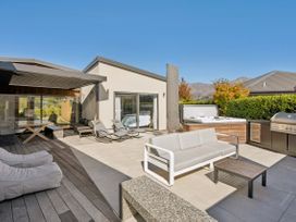 An outdoor patio with seating and a hot tub at Casa Central - Wanaka Holiday Home Wanaka
