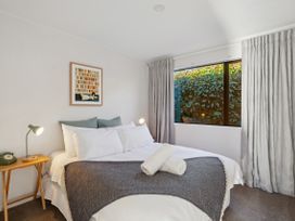 A bedroom with a bed and nightstand at Frankton Favourite - Queenstown Holiday Home, Queenstown