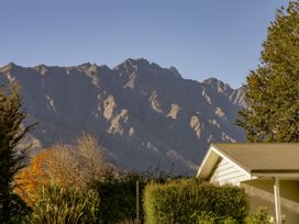 A house with mountains in the background at Frankton Favourite - Queenstown Holiday Home, Queenstown