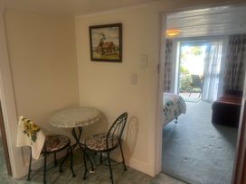 A dining area with a table and chairs at The Beach House - Paihia Holiday Home