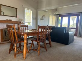 A dining room with a table and chairs at The Beach House - Paihia