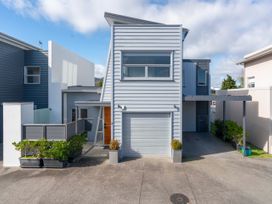 A house with a garage and plant pots at Fresh on Fletcher - Lake Taupo