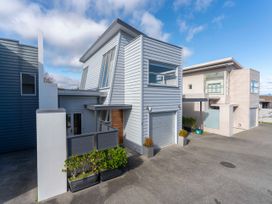 A modern house with garage and plants at Fresh on Fletcher - Taupo Holiday Home Lake Taupo