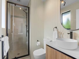 A bathroom with a shower and sink at The Summer Pad - Omaha Holiday Home