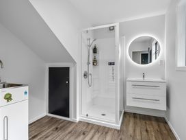 A bathroom with a shower and sink at Coastal Charm - Picton Holiday Home, Picton