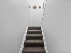A stairway with carpeted steps and ship decor at Coastal Charm - Picton Holiday Home in Picton