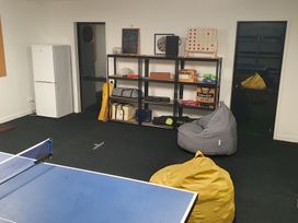 A game room with a ping pong table and bean bags at Mangawhai Magic - Mangawhai Heads
