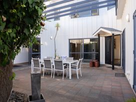 An outdoor patio with a dining table and chairs at Omaha Beach House in Omaha