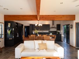A living room with a sofa and dining area at Omaha Beach House - Omaha