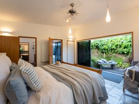 A bedroom with a bed and access to an outdoor area at Omaha Beach House - Omaha