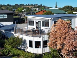 A house with a deck and outdoor seating at Omaha Beach House in Omaha