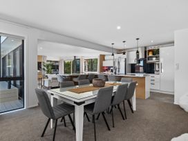 A dining room and kitchen area at Sun Kissed Pool Villa - Mangawhai Holiday Home Mangawhai Heads