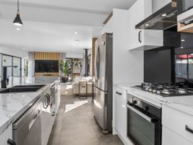 A kitchen with appliances at Sun Kissed Pool Villa - Mangawhai Holiday Home Mangawhai Heads