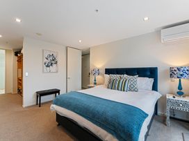 A bedroom with a bed and nightstands at Waimahana 5 - Taupo Holiday Apartment in Waipahihi